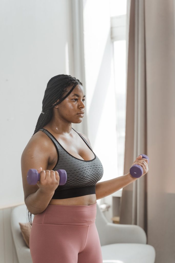 pexels-mart-production-8846565 A woman exercising in her home
